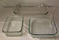 Top-down view showing three clear glass baking dishes of different sizes