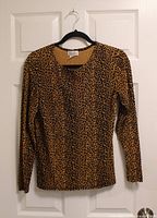 Full view of leopard print JONDON long sleeve blouse on hanger