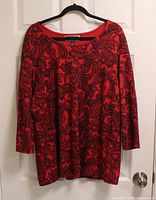 Front view of Karen Scott red paisley blouse hanging