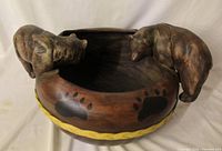 Overall view of ceramic bowl with two bear figurines and exterior design