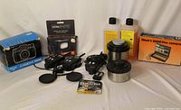 All items group shot including boxed cameras, transceivers, flash, developing tanks, chemicals and batteries