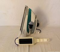Side view of Black & Decker steam iron and lint brush