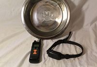 remote transmitter, receiver collar, stainless bowl visible together