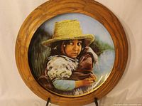 Front view of framed collector plate showing artwork of girl with straw hat