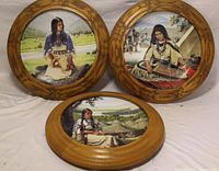 three framed plates displayed
