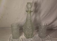 Front view showing decanter with stopper and two matching tumblers