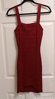 Front view of red Guess bodycon dress on hanger