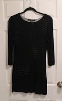 Front view of black Le Chateau perforated knit dress hanging to show style, pattern, sleeves and length