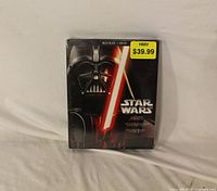 Front view of sealed Star Wars Original Trilogy Blu-ray + DVD set showing artwork and price sticker