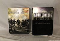 Front view of both metal tin DVD box sets: The Pacific and Band of Brothers