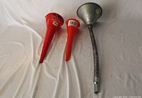 Three funnels laid out showing sizes and materials