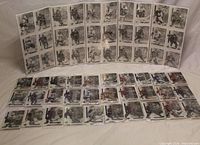 overview of sealed card packs and opened album pages