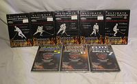 Front view of eight hockey instructional DVDs showing titles and cover art