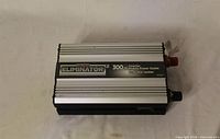 Front angled view of Eliminator 300W power inverter showing housing and label
