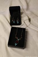 Necklace with pendant and matching earrings in boxes
