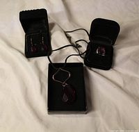 All three jewellery pieces displayed in boxes