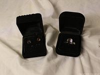 Ring and earrings in velvet boxes showing stone colour and settings