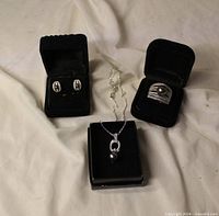 Ring, necklace and earrings with imitation black pearls in boxes