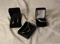 Jewelry set laid out in boxes: necklace, bracelet, earrings