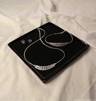 Full view of necklace, bracelet and earrings displayed in presentation box