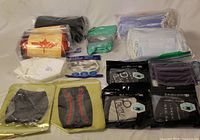 Group of fifteen packaged cloth and disposable masks laid out