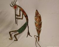 Front view of Kokopelli and feather metal art