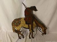 overall view of painted metal silhouette horseback rider wall art