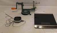 Apple peeler, digital thermometer with probe, Taylor scale on surface