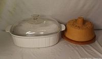 CorningWare casserole with lid and ceramic tortilla warmer side by side