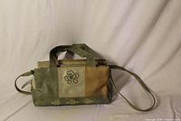 Full exterior view of patchwork purse showing colors, handles, long strap and embroidery