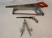 Group shot of Sandvik crosscut saw, Mastercraft hacksaw, keyhole saw, and Alltrade multi-tool