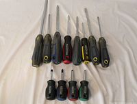 All twelve Mastercraft screwdrivers arranged in two rows showing varying lengths and colored handle caps