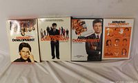 Front view of four Arrested Development DVD box sets Seasons 1-4