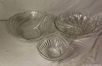 Three clear glass serving bowls grouped together