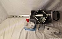 Complete lot showing shag box with tube, golf balls, tees container and gloves