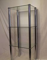 Full view of chrome frame with three glass shelves