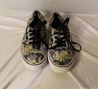 Front view of both sneakers showing Disney character print, laces, midsole