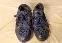 Pair of navy lace sneakers top view showing uppers and laces