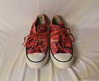 Top view of both sneakers showing uppers, laces, toe caps and overall wear