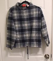 Front view of navy and white plaid Liz Claiborne sweater on hanger