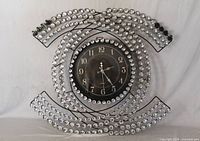 Front view of decorative wall clock showing entire frame and dial