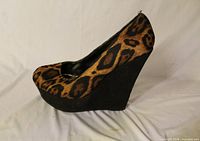 Left side view of leopard print wedge showing pattern and wedge height