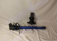 Chinook mast base and blue skinny mast extension laying on white backdrop