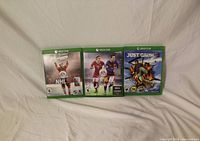 Front view of three Xbox One game cases: NHL 16, FIFA 16, Just Cause 3