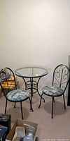 bistro set showing glass table and two chairs