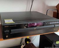 Front and top view of Denon DCM-360 CD player on shelf
