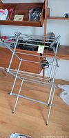 Drying rack partially unfolded showing cross-frame and rods