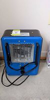 Front view of blue Mastercraft heater with grill, handles and power cord