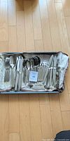 Tray with assorted stainless steel knives, forks, spoons