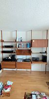 Full view of teak wall unit assembled against wall